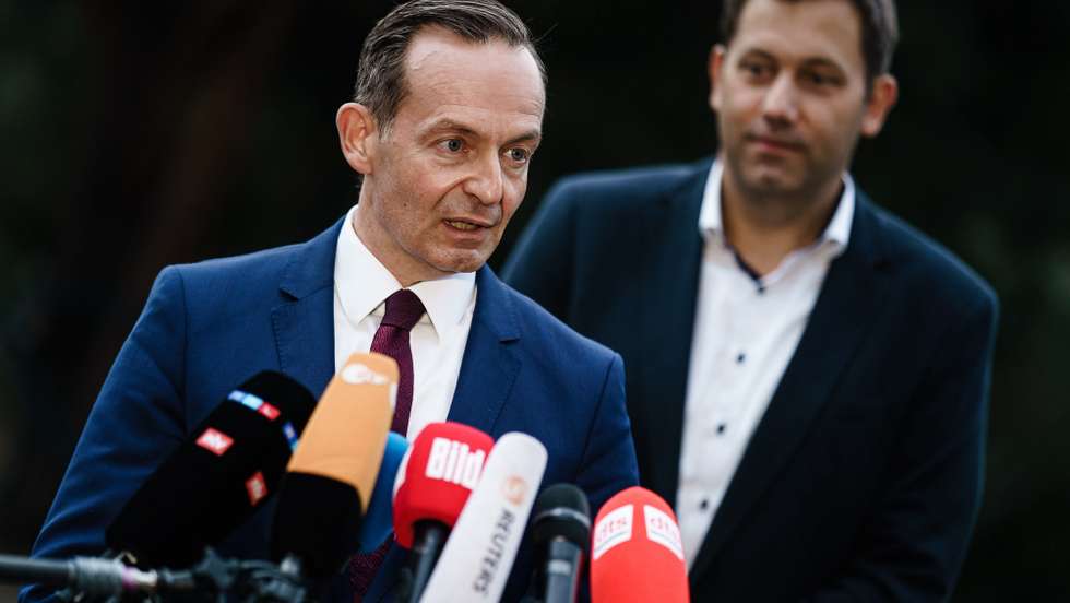 epa09503907 Free Democratic Party (FDP) General Secretary Volker Wissing (L) talks to media next to Social Democratic Party (SPD) Secretary General Lars Klingbeil (R) during a joint statement after exploratory talks in Berlin, Germany, 03 October 2021. Representatives of Social Democrats (SPD) and Free Democratic Party (FDP) met in search for coalition possibilities after Germany's recent parliamentary election.  EPA/CLEMENS BILAN
