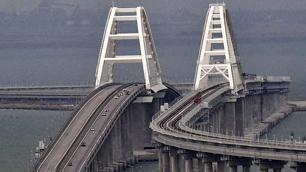 epa10232212 Cars move on the Kerch Strait bridge in Crimea, 09 October 2022. Automobile traffic on the undamaged part of the Crimean bridge has been restored, the head of the annexed Crimea Sergey Aksyonov announced. The previous day, Russian authorities said that "an explosion was set off at a cargo vehicle on the motorway part of the Crimean bridge on the side of the Taman peninsula, which set fire to seven fuel tanks of a train that was en route to the Crimean peninsula. Two motorway sections of the bridge partially collapsed."  EPA/STRINGER