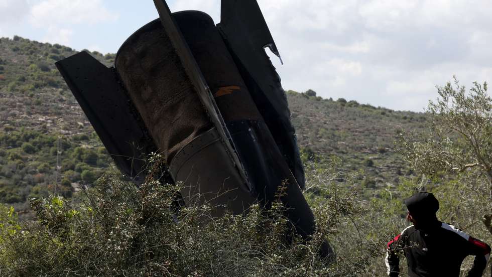 epaselect epa12845607 Palestinians inspect the remains of a ballistic missile that landed in the West Bank village of Haris, near Salfit, 24 March 2026. The Israeli military reported that it detected multiple waves of missiles launched from Iran towards Israel throughout the morning.  EPA/ALAA BADARNEH