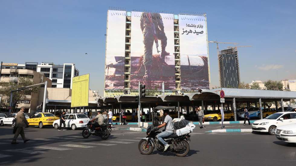 epaselect epa13302663 Iranians drive past an anti-US billboard depicting a member of Iran's Revolutionary Guard (IRGC) placing his foot on a US unmanned underwater vehicle that Iran claims to have seized in the Strait of Hormuz, with the Persian words 'Hormuz Catch', in Vanak Square in Tehran, Iran, 14 October 2026, amid the ongoing conflict between Iran and the United States.  EPA/ABEDIN TAHERKENAREH RESTRICTIONS: NO Access Israel Media/Persian Language TV Stations Outside Iran/Strictly No Access BBC Persian/VOA Persian/Manoto TV/Iran International TV. (As mandated by Iran's Directorate General for Foreign Media) --
