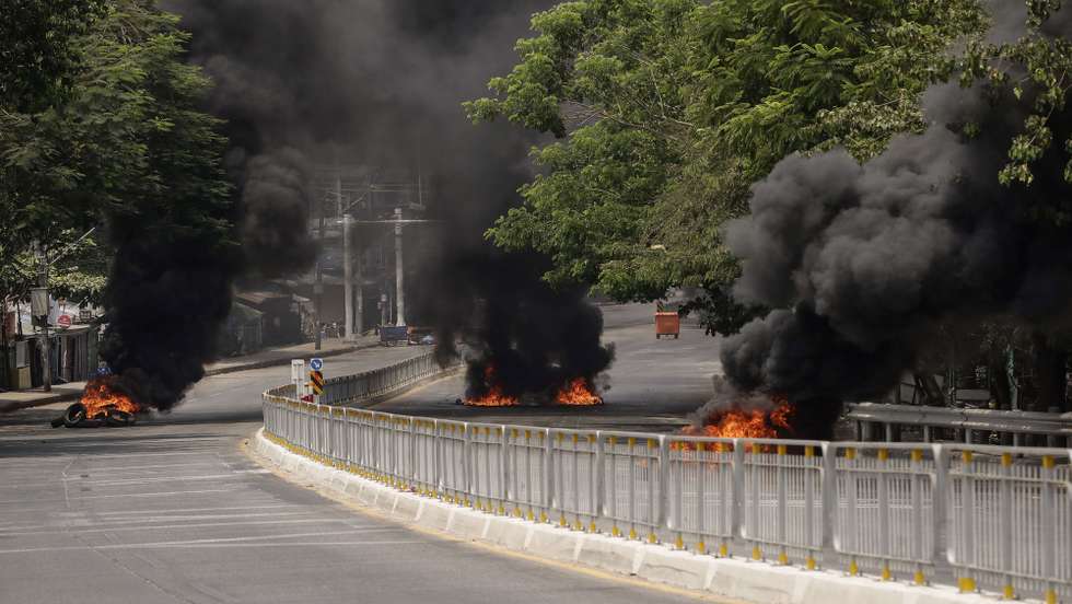 epa09100501 Burning roadblocks during a protest against the military coup, in Yangon, Myanmar, 27 March 2021. Anti-coup protests continue as Myanmar's junta held a military parade on 27 March in a major show of strength to mark the annual Armed Forces Day, in the capital Naypyidaw  EPA/STRINGER