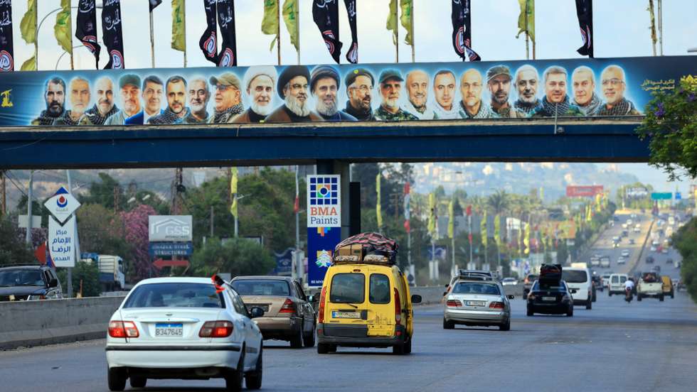 epaselect epa13058692 Lebanese people drive a vehicle loaded with mattresses as they return to their village, passing by pictures of late Hezbollah leaders on the Deir Zahrani highway, southern Lebanon, 23 June 2026, amid a ceasefire between Israel and Hezbollah. A comprehensive joint report by the United Nations Development Programme (UNDP) and the Lebanese National Council for Scientific Research (CNRS-L) estimated direct building damage in South Lebanon at 1.38 billion US dollar. The assessment found over 11,000 buildings completely destroyed and 3.1 million cubic meters of debris, structurally affecting more than 41,000 housing units.  EPA/WAEL HAMZEH