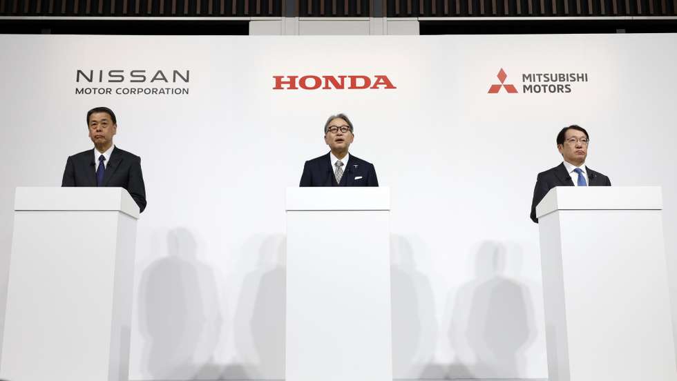 epa11790643 (L-R) Nissan Motor Co. President and CEO Makoto Uchida, Honda Motor Co. President Toshihiro Mibe, and Mitsubishi Motors Corp. President and CEO Takao Kato speak during a joint press conference in Tokyo, Japan, 23 December 2024. Nissan, Honda, and Mitsubishi Motors have signed a memorandum of understanding (MOU) to explore Mitsubishi Motors’ potential participation and synergy-sharing in the business integration outlined in a previous MOU between Nissan and Honda.  EPA/FRANCK ROBICHON