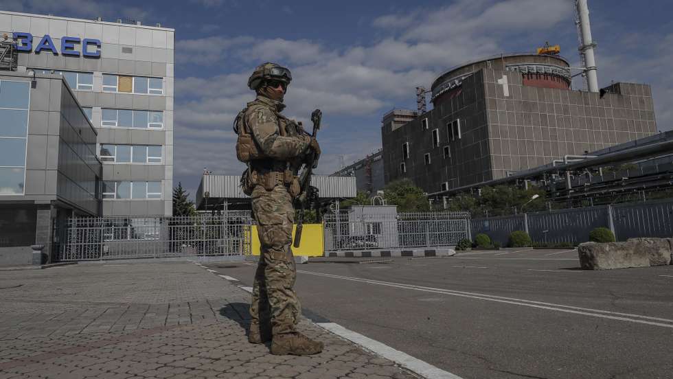 epa09921718 A picture taken during a visit to Mariupol organized by the Russian military shows Russian serviceman on guard in front of the  Zaporizhzhia Nuclear Power Station in Enerhodar, southeastern Ukraine,  01 May 2022. The Zaporizhzhia Nuclear Power Station is under control of the Russian National Guard, the Ukrainian military that guarded the facility handed over their weapons and were released on 09 March according to Andriy Shevchik, head of the Enerhodar city administration. On 24 February Russian troops entered Ukrainian territory in what the Russian president declared a 'special military operation', resulting in fighting and destruction in the country, a huge flow of refugees, and multiple sanctions against Russia.  EPA/SERGEI ILNITSKY
