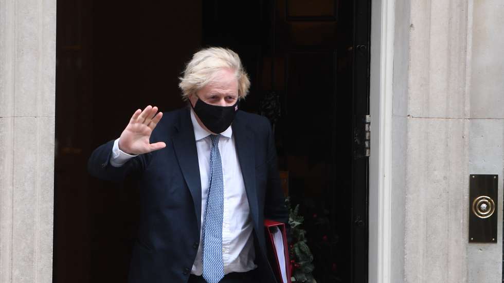 epa09629263 British Prime Minister Boris Johnson departs Downing Street to attend Prime Minister's Questions (PMQ) in London, Britain, 08 December 2021. Johnson faces questions amid allegations that Downing Street staff held a party during the Covid-19 lockdown on Christmas 2020.  EPA/NEIL HALL