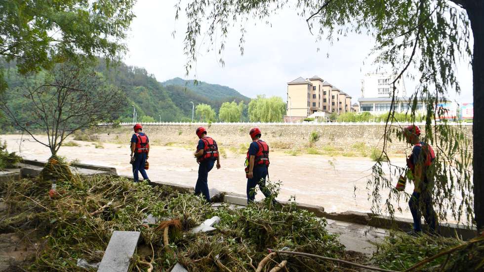 epa12211867 Rescuers search for missing individuals in Erlangping Town of Xixia County, Nanyang City, central China's Henan Province, 02 July 2025 (issued 03 July 2025). Torrential downpours in Taiping and Erlangping triggered a sudden surge in the water level in the downstream of a local river in Xixia County on 30 June, damaging infrastructure and leaving some residents trapped. Following the flooding, rescue efforts were immediately implemented, with two people successfully rescued. Further search and rescue efforts are underway in the quest to locate the three missing individuals.  EPA/XINHUA / HAO YUAN CHINA OUT / UK AND IRELAND OUT  /       MANDATORY CREDIT EDITORIAL USE ONLY