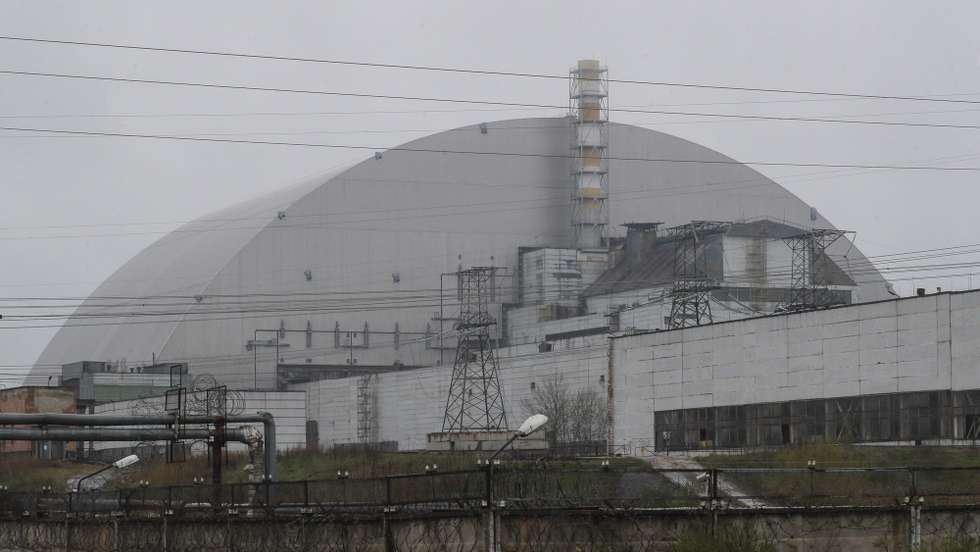 epa09910559 The protective shelter over the remains of the nuclear reactor Unit 4 at the Chernobyl nuclear power plant near the city of Chernobyl, Ukraine, 26 April 2022. Ukraine marks the 36th anniversary of the Chernobyl tragedy on 26 April 2022. The explosion of reactor 4 of the Chernobyl nuclear power plant in the early hours of 26 April 1986 is still regarded as the worst nuclear disaster to date.  EPA/SERGEY DOLZHENKO