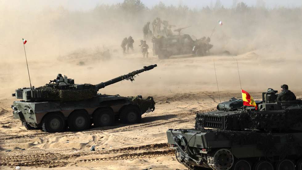epa09817834 Spanish Army serviceman with their battle tank Leopard (R) during the international military exercise Crystal Arrow 22, organized by Mechanized Infantry Brigade of the Latvian Land Forces in Adazi training ground, Latvia, 11 March 2022. The purpose of the force demonstration is to demonstrate the interoperability of multinational units in various operations and to demonstrate NATO's combat capabilities for the protection of any member of the Alliance. With the conclusion of the Crystal Arrow 2022 exercise, the certification process of the NATO Extended Presence Battlegroup in Latvia is being successfully completed.  EPA/TOMS KALNINS