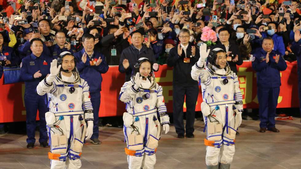 epa09525898 (L-R) Astronauts Ye Guangfu, Zhai Zhigang, and Wang Yaping, greet the crowd before their departure to Tiangong space station at the Jiuquan Satellite Launch Center in northwest China, 15 October 2021. The trio will stay in orbit for six months, a regular duration for future Tianhe space station visitors.  EPA/LIU HUAIYU CHINA OUT