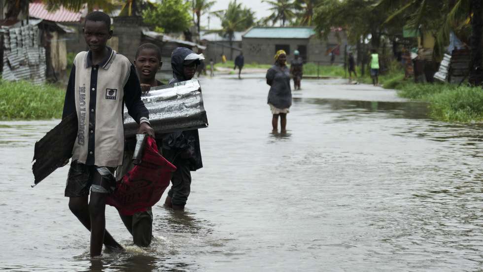Kids passes on a flooded street near Quelimane, as the storm Freddy hits Mozambique, 11 March 2023. The provincial capital of Quelimane will be the largest urban area closest to the cyclone's point of arrival on the mainland, and its radius (of about 300 kilometres) is expected to extend from Marromeu to Pebane, then moving inland towards Cherimane and southern Malawi. This is one of the longest lasting storms ever, after it formed at the beginning of February in the Asian seas, crossing the entire Indian Ocean to the east African coast. ANDRE CATUEIRA/LUSA