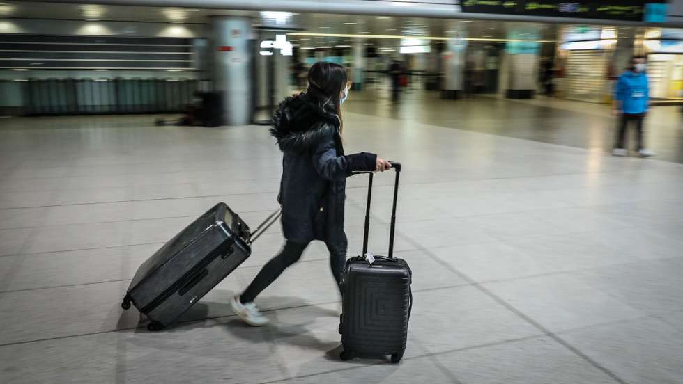 A passenger passes by the departure terminal of Lisbon airport, Lisbon, Portugal, February 1, 2021. Portugal has extended until 14th February the restrictive measures concerning air traffic from outside the European Union (EU) and the Schengen Area, which remains limited to "essential travel" and subject to a negative prior test to covid-19.  MIGUEL A. LOPES/LUSA