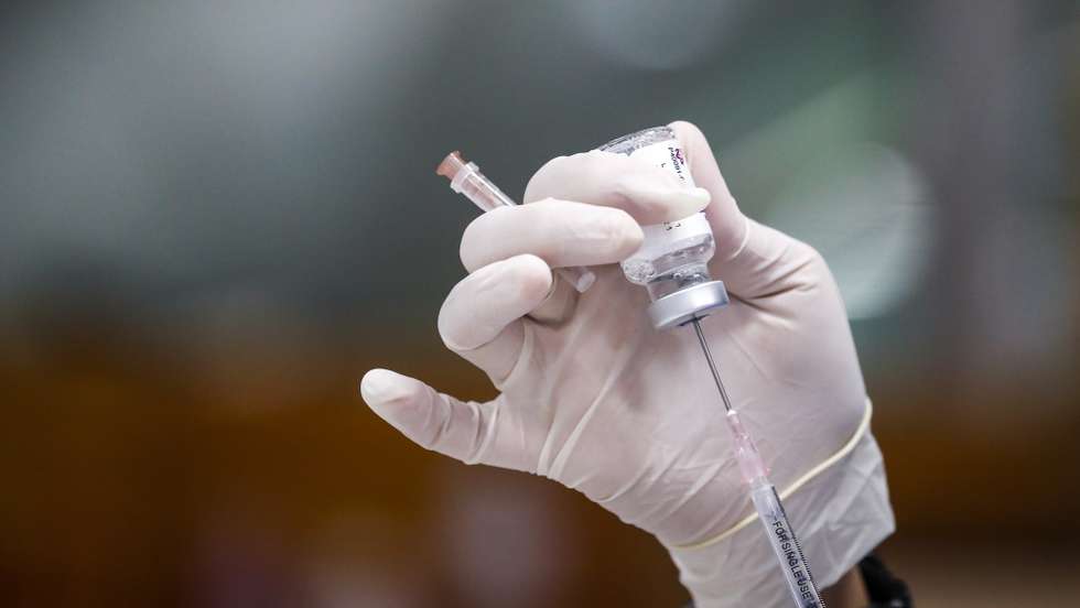 epa09330892 A Thai health official prepares a syringe with AstraZenca COVID-19 vaccine at a vaccination center set up inside the Bang Sue Grand Station in Bangkok, Thailand, 08 July 2021. Bangkok is considering to impose a new lockdown after recording 75 deaths and over 7,000 new COVID-19 infections according to the Centre for Covid-19 Situation Administration.  EPA/DIEGO AZUBEL