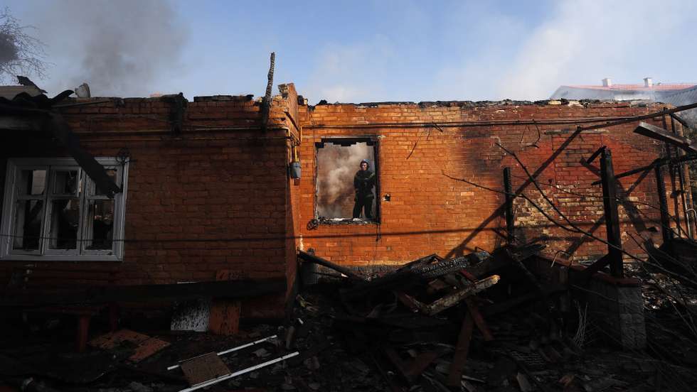 epa09844588 Ukrainian firefighters work at the house that was targeted by Russian attack in Kiev (Kyiv), Ukraine,  23 March 2022,  Russian troops entered Ukraine on 24 February prompting the country's president to declare martial law and triggering a series of announcements by Western countries to impose severe economic sanctions on Russia  EPA/ATEF SAFADI