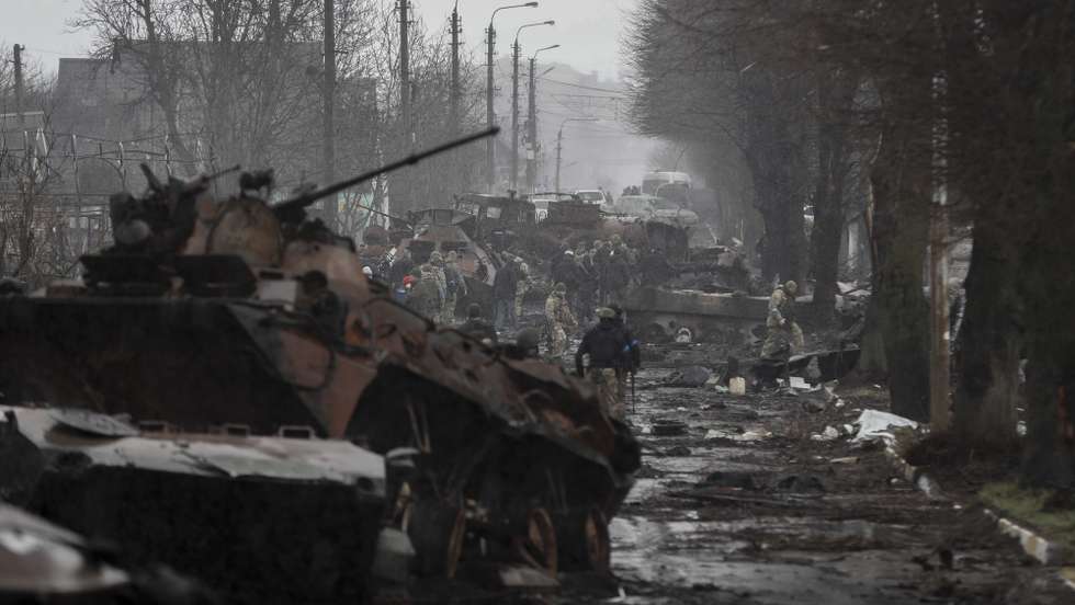 epa09868169 Ukrainian soldiers inspect destroyed Russian military machinery in the areas recaptured by the Ukrainian army in the city of Bucha, Ukraine, 03 April 2022. Dmitrivka and the area around had recently been recaptured by the Ukrainian army from Russian forces. On 24 February, Russian troops had entered Ukrainian territory in what the Russian president declared a 'special military operation', resulting in fighting and destruction in the country, a huge flow of refugees, and multiple sanctions against Russia.  EPA/ATEF SAFADI