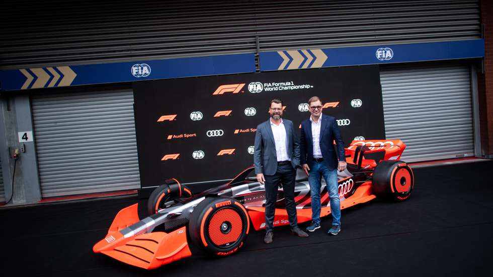 epa10139482 Audi Chief Development Officer Oliver Hoffmann (L), and Chairman of the executive board of German manufacturer Audi Markus Duesmann (R) pose next to the new Audi F1 car following a press conference of the Formula One Grand Prix of Belgium at the Spa-Francorchamps race track in Stavelot, Belgium, 26 August 2022. The Belgian Formula One Grand Prix will take place on 28 August 2022. Audi announced they will enter Formula One in 2026.  EPA/CHRISTIAN BRUNA