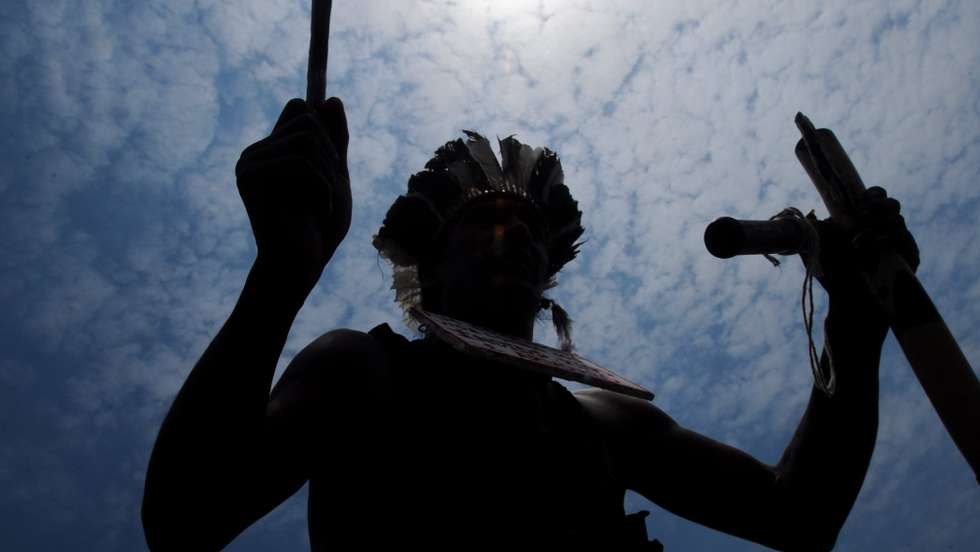 epa03453703 Indians and students participate at a demonstration in Brasilia, Brazil on 31 October 2012, supporting the native Indian tribe kaiowá-guaraní that lives in lands that have been claimed by landownings from Brazilian state Mato Grosso do Sul. A Brazilian court has guaranteed a temporary stay for 170 Indians kaiowá-guaraní in those lands that have been theirs for centuries. The conflict has created controversies such as the spreading of tribal dances videos made apparently to set a 'collective suicidal ceremony' after a court's decision to vacate the lands.  EPA/FERNANDO BIZERRA JR