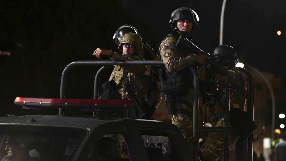 epa10362704 Police try to disperse a demonstration by supporters of the outgoing President of Brazil, Jair Bolsonaro, in Brasilia, Brazil, 12 December 2022. Followers of Bolsonaro tried to invade one of the Federal Police headquarters in Brasilia in retaliation for the arrest of one of their leaders, who is calling for a coup. The demonstrators set fire to vehicles parked at the police headquarters.  EPA/Andre Borges