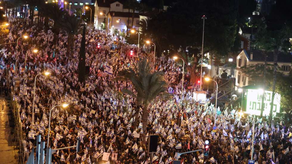 epa10447718 People wave Israeli flags as they take part in a protest against the government in Tel Aviv, Israel, 04 February 2023. Thousands gathered to protest against the newly-formed government of Prime Minister Benjamin Netanyahu amid reports of government's intention to reform judicial system which critics say would weaken the power of the Israeli Supreme Court.  EPA/ABIR SULTAN