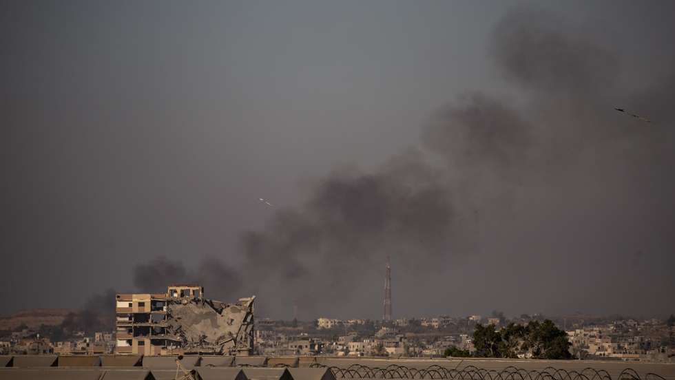 epa11537617 Smoke rises following an Israeli airstrike as Palestinians flee from Khan Yunis after a new evacuation order was issued by the Israel Defense Forces (IDF), Khan Yunis camp in the southern Gaza Strip, 08 Aug 2024. Since 07 October 2023, up to 1.7 million people, or more than 75 percent of the population, have been displaced throughout the Gaza Strip, some more than once, in search of safety, according to the United Nations Relief and Works Agency for Palestine Refugees in the Near East (UNRWA), which added that the Palestinian enclave is 'on the brink of famine', with 1.1 million people (half of its population) 'experiencing catastrophic food insecurity' due to the conflict and restrictions on humanitarian access.  EPA/HAITHAM IMAD