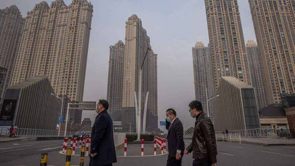 epa08959714 People wearing protective face masks cross a road, on the day of Wuhan's lockdown one-year anniversary, in Wuhan, China, 23 January 2021. The day 23 January 2021 marks the one-year anniversary of the start of a strict 76-day lockdown of the Chinese city of Wuhan, where the novel coronavirus SARS-CoV-2 that causes the COVID-19 disease, was first discovered before spreading across the world into a deadly global pandemic.  EPA/ROMAN PILIPEY