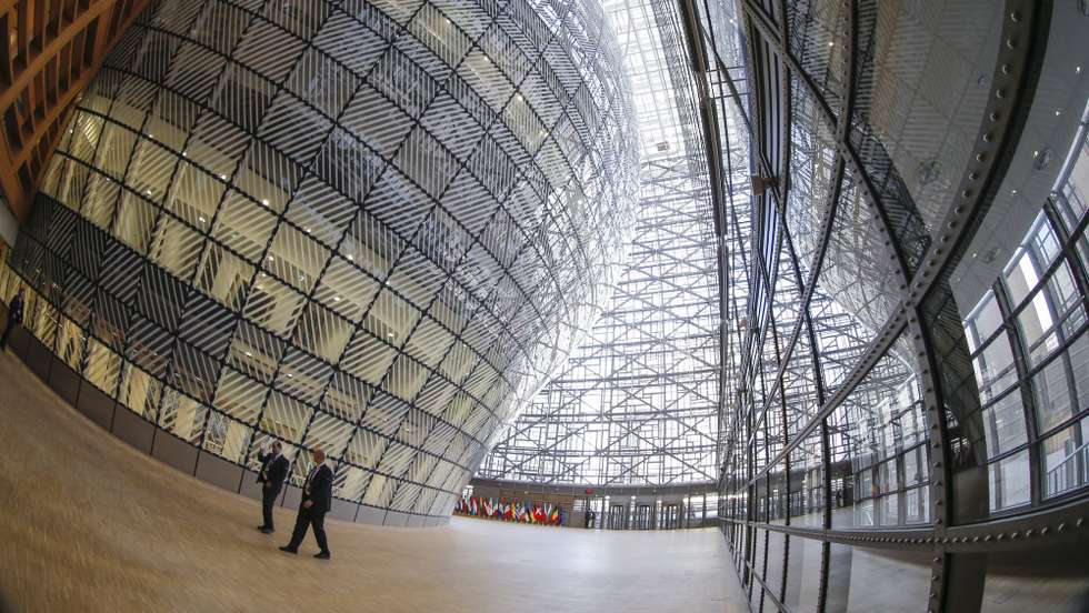 epa05744389 The image taken with a fisheye lens shows the atrium of the new Europa Building in Brussels, Belgium, 23 January 2016.   Located at the heart of the European district, the Europa building combines a new part, a lantern-shaped structure designed by the consortium of Samyn and Partners (Belgium), Studio Valle Progettazioni (Italy) and Buro Happold (UK) with a renovated section of Art Deco complex designed by architect Michel Polak in 1922. The building is plan to host European council and summits.  EPA/OLIVIER HOSLET
