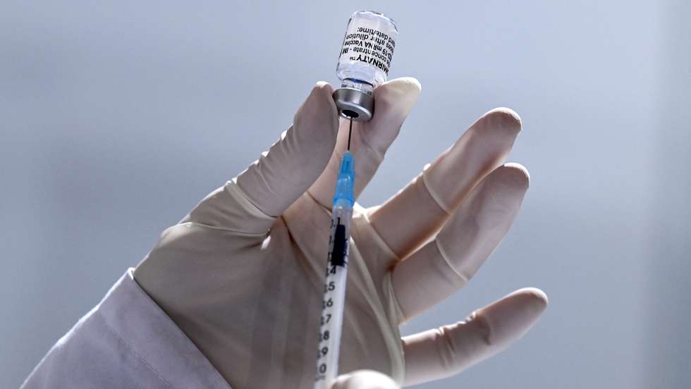 epa09154597 A medical staff prepares dose of Pfizer-BioNTech COVID-19 vaccine during the vaccination at the Arena 'Boris Trajkoovski' in Skopje, Republic of North Macedonia, 23 April 2021. Members of Macedonian Parliament received first dose of Russian Sputnik V vaccine on 23 April as the country continues its coronavirus disease (COVID-19) vaccination campaign with elderly people and critical groups for the state infrastructure.  EPA/GEORGI LICOVSKI