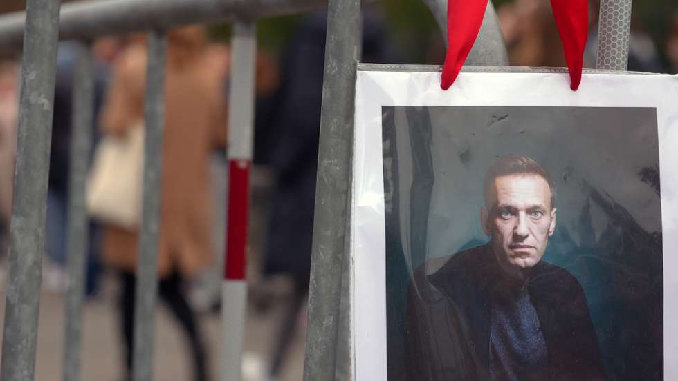 epa11226186 A portrait of Alexei Navalny is seen as Russians living in Switzerland gather in front of the Russian embassy in Bern to take their vote during the Russian presidential elections and simultaneously protest against President Putin in Bern, Switzerland, 17 March 2024. The Russian presidential election vote takes place between 15 and 17 March. Four candidates registered by the Central Election Commission of the Russian Federation are vying for the post of head of state: Leonid Slutsky, Nikolai Kharitonov, Vladislav Davankov and Vladimir Putin.  The team of late Russian opposition leader Alexei Navalny had called Russians to show their opposition to the elections and President Putin, by crowding voting centers on 17 March at midday. The protest was named 'Noon Against Putin'.  EPA/JULIEN GRINDAT