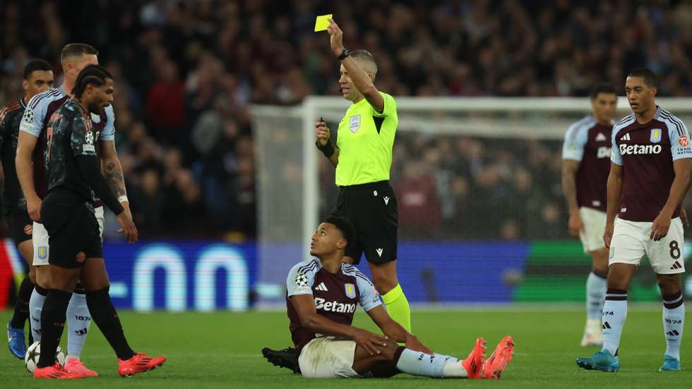 epa11638738 Serge Gnabry of Bayern is shown a yellow card by Referee Radu Petrescu during the UEFA Champions League soccer match between Aston Villa and Bayern Munich in Birmingham, Britain, 02 October 2024.  EPA/NEIL HALL