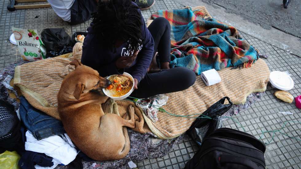 epa08379755 Homeless and unemployed people receive a plate of food from the Franciscan Solidarity Association of Sao Paulo, which at the height of the coronavirus outbreak is distributing around 3,000 lunches and dinners every day to people in need in Sao Paulo, Brazil, 20 April 2020 (issued 23 April 2020). Hundreds of families are weathering the coronavirus pandemic while locked up in their homes thanks to donations from civil society and their neighbors. According to the latest official data from 2018, extreme poverty in Brazil has reached its highest level since 2012, with 6.5 percent of the population (around 13.5 million people) living on incomes of less than 1.9 US dollars per day. In addition, a quarter of the Brazilian population â€“ some 50 million people â€“ are classified as poor, that is, they live on less than 5.5 dollars a day.  EPA/FERNANDO BIZERRA