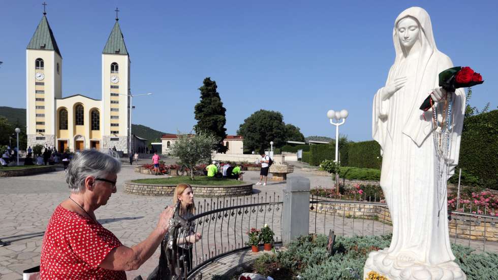 epa10710815 Pilgrims pray in front of the statue of Our Lady of Medjugorje, in the village of Medjugorje, Bosnia and Herzegovina, 25 June 2023. Pilgrims gathered in Medjugorje to mark the 42nd anniversary of the alleged appearance of the Virgin Mary to local shepherds in the hills surrounding the village on 24 June 1981. More than 30 million people are believed to have visited the world-famous village since the Virgin's first appearance, which the Catholic Church has not yet recognized.  EPA/FEHIM DEMIR