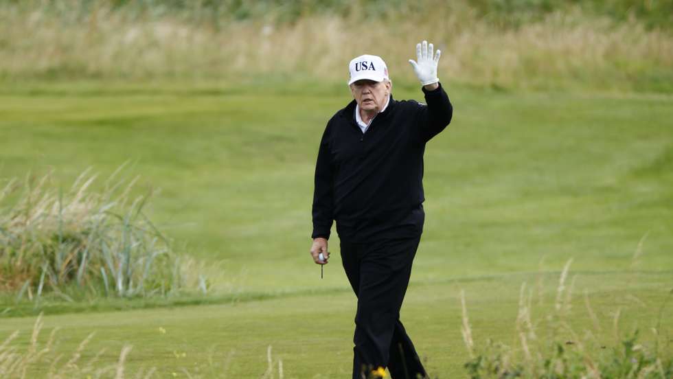 epaselect epa12263314 US President Donald J. Trump waves as he plays golf at Trump Turnberry golf course during a private visit in Turnberry, Scotland, Britain, 26 July 2025.  US President Trump is visiting Scotland where he will visit his golf courses and meet with UK Prime Minister Keir Starmer.  EPA/TOLGA AKMEN