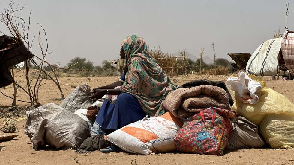 epa12049103 A Sudanese woman, who fled from the internally displaced persons (IDP) Zamzam camp, rests while on her way to the Tawila Camps amid the ongoing conflict between Sudan's army and the Rapid Support Forces (RSF), in North Darfur, Sudan, 23 April 2025. The RSF claimed control of the Zamzam camp after its assault in April 2025. According to the UNHCR, over four million people have fled Sudan to neighboring countries since the outbreak of the armed conflict in April 2023.  EPA/MARWAN MOHAMED