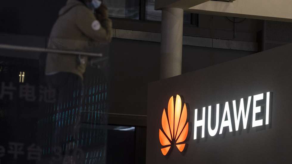 epa09148983 A man stands in front of the Huawei trade fair stand during the first day of the Auto Shanghai 2021 motor show in Shanghai, China, 21 April 2021. The 19th International Automobile Industry Exhibition runs from 24 to 28 April.  EPA/Alex Plavevski