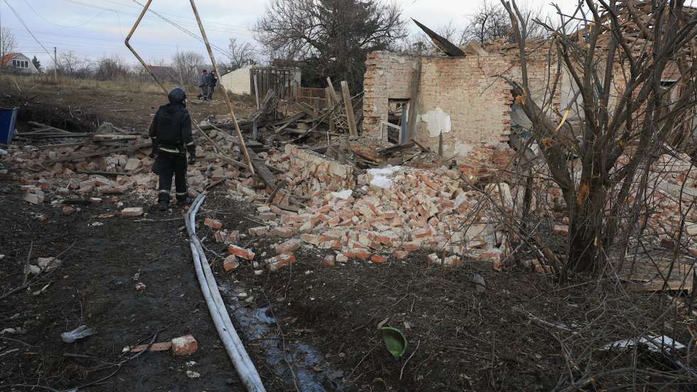 epa11792935 A Ukrainian rescuer works at the site of an airstrike on a private building in Kharkiv, northeastern Ukraine, 25 December 2024, amid the Russian invasion. According to the State Emergency Service of Ukraine (SESU), at least six people were injured in the northeastern Ukrainian city of Kharkiv after Russia launched a missile and drone attack across Ukraine on 25 December.  EPA/SERGEY KOZLOV