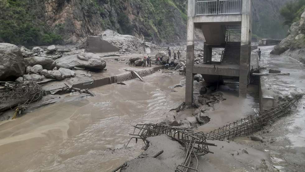 epa12223678 A handout photo made available by the Nepali Army shows Nepalese soldiers during a rescue operation in the flood-affected area of Rasuwagadhi, Nepal, 08 July 2025. According to the Rasuwa District Police Office, the floodwaters swept away the Miteri Bridge, the main connecting bridge between Nepal and China, halting the movement of people and vehicles across the border and leaving at least 18 people missing.  EPA/NEPAL ARMY/HANDOUT  -- BEST QUALITY AVAILABLE -- HANDOUT EDITORIAL USE ONLY/NO SALES