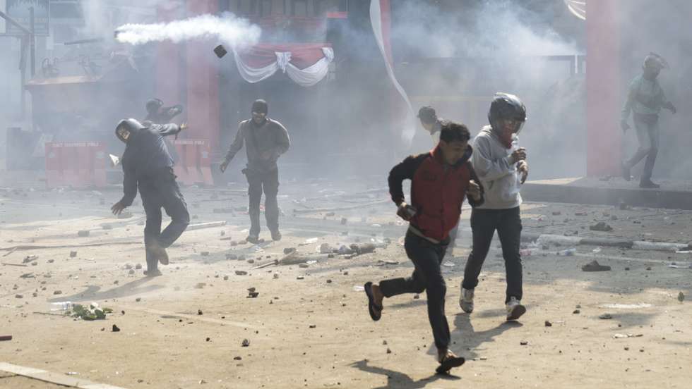 epa12333567 People throw stones during a protest outside of the Mobile Brigade Police headquarters in Jakarta, Indonesia, 29 August 2025. Hundreds of civilians, including motorcycle taxi drivers, protested in Jakarta after the death of a driver who was allegedly run over by a police vehicle during demonstrations on the night of 28 August.  EPA/BAGUS INDAHONO