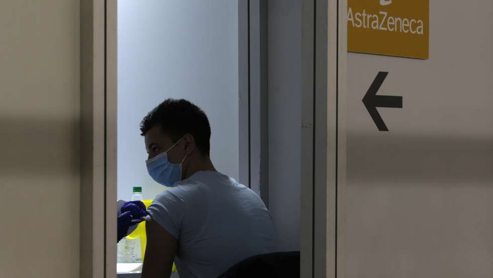 epa09100831 A man receives a dose of AstraZeneca vaccine at the Belgrade Fair vaccination center in Belgrade, Serbia, 27 March 2021. Thousands of vaccine-seekers from neighboring countries like Bosnia and Herzegovina, North Macedonia and Montenegro have crowded the Belgrade's main vaccination center after Serbian authorities offered free coronavirus jabs for foreigners if they show up over the weekend.  EPA/ANDREJ CUKIC