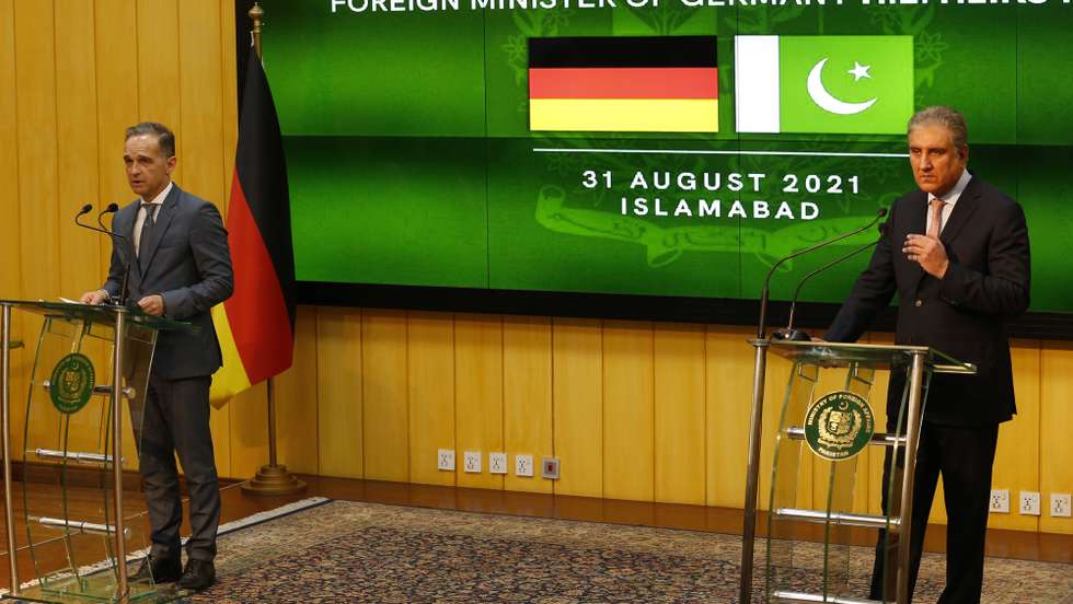 epa09438410 German Foreign Minister Heiko Maas talks (L) talks with journalists during a joint press conference with Pakistan's Foreign Minister Shah Mahmood Qureshi (R) in Islamabad, Pakistan, 31 August 2021. German Foreign Minister Heiko Maas is on an official visit to Islamabad to discuss issues of mutual interests and regional security.  EPA/SOHAIL SHAHZAD