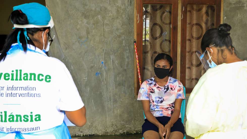 epa09075520 Healthcare workers get information from a woman shortly before collecting the specimen samples during a COVID-19 swab test in Dili, East Timor also known as Timor Leste, 15 March 2021. Timor Leste recorded the second-smallest covid-19 outbreak in Southeast Asia after Laos, reporting just 145 cases of the coronavirus. The country had imposed a state of emergency a week after detecting its first case on 21 March 2020, and enforced strict border controls.  EPA/ANTONIO DASIPARU