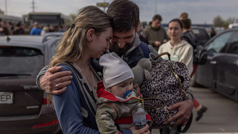 epa09924897 A man welcomes Anna and her son Svyatoslav who were evacuated from Mariupol at the evacuation point in Zaporizhzhia, Ukraine, 03 May 2022. Around 100 civilians were evacuated from the steel plant, the last Ukrainian-controlled area in the southern port city of Mariupol, according to Ukrainian officials. Thousands of people who were still in Mariupol and other areas in South Ukraine occupied by the Russian army waited to be evacuated to Ukraine's controlled area by buses and their own cars.  EPA/ROMAN PILIPEY