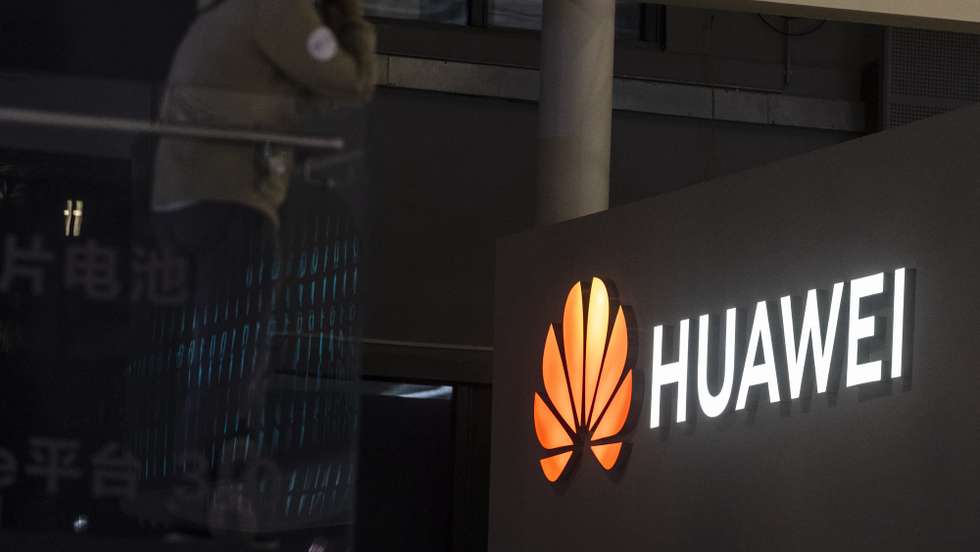 epa09148983 A man stands in front of the Huawei trade fair stand during the first day of the Auto Shanghai 2021 motor show in Shanghai, China, 21 April 2021. The 19th International Automobile Industry Exhibition runs from 24 to 28 April.  EPA/Alex Plavevski