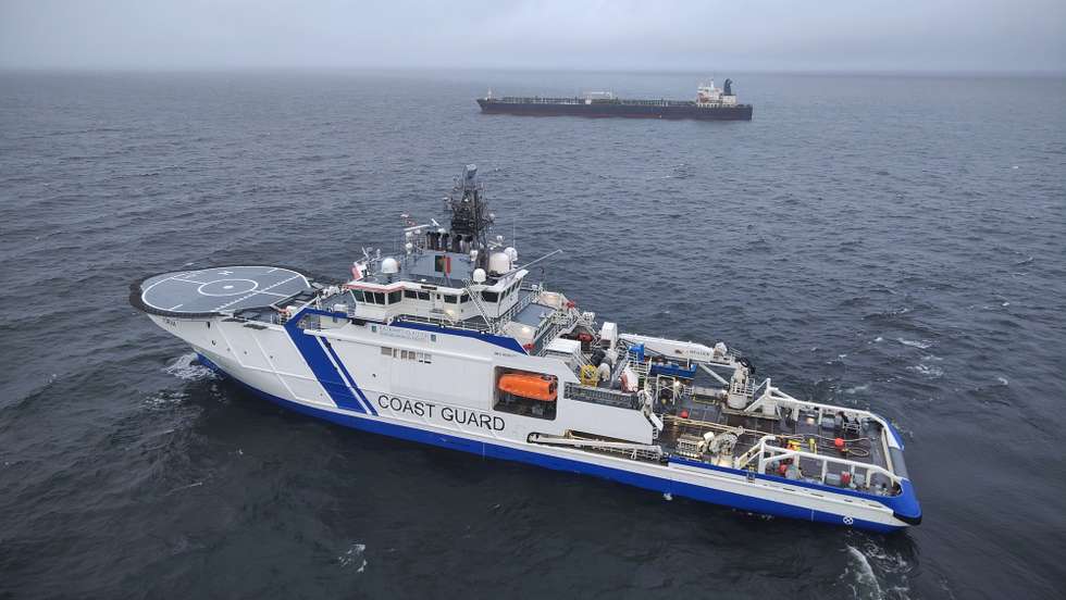 epa11795031 A handout photo dated made available by the Finnish Border Guard on 27 December 2024 shows a border guard vessel and tanker Eagle S off Porkkalanniemi peninsula, Finland, 27 December 2024. Finnish authorities are investigating the Eagle S, an oil tanker registered with the Cook Islands, suspected of having caused the outage of an undersea power cable connecting Finland and Estonia on 25 December.  EPA/HANDOUT HANDOUT EDITORIAL USE ONLY/NO SALES