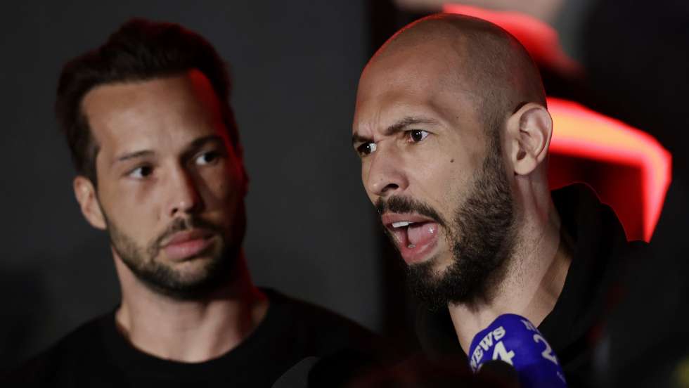 epa11980126 Former professional kickboxer and social media influencer Andrew Tate (R), accompanied by his brother Tristan (L), speaks with TV reporters after returning from a trip in the United States, in front of their property, in Bucharest, Romania, early 22 March 2025. After spending weeks in the USA, Tate brothers returned to Romania, where they face legal charges. Andrew Tate and his brother Tristan were arrested on 29 December 2022 as a result of the DIICOT (Directorate for Investigating Organized Crime and Terrorism) inquiry on charges of human trafficking and intention to form an organized crime group. Romanian police allege that the two brothers and their associates coerced victims for creating a paid pornography service for social media platforms. The trial itself has not started yet, as the appeal court judges sent the case back to DIICOT prosecutors by a decision made at the end of 2024.  EPA/Robert Ghement