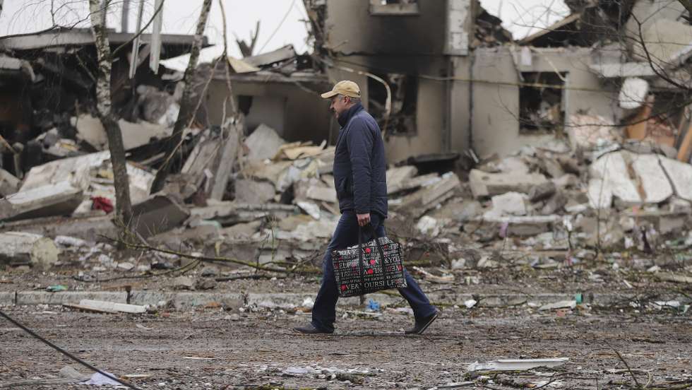 epaselect epa09799166 A man goes past burned buildings that were hit by shelling in the small city of Borodyanka near Kiev, Ukraine, 03 March 2022. Russian troops entered Ukraine on 24 February prompting the country's president to declare martial law.  EPA/ALISA YAKUBOVYCH
