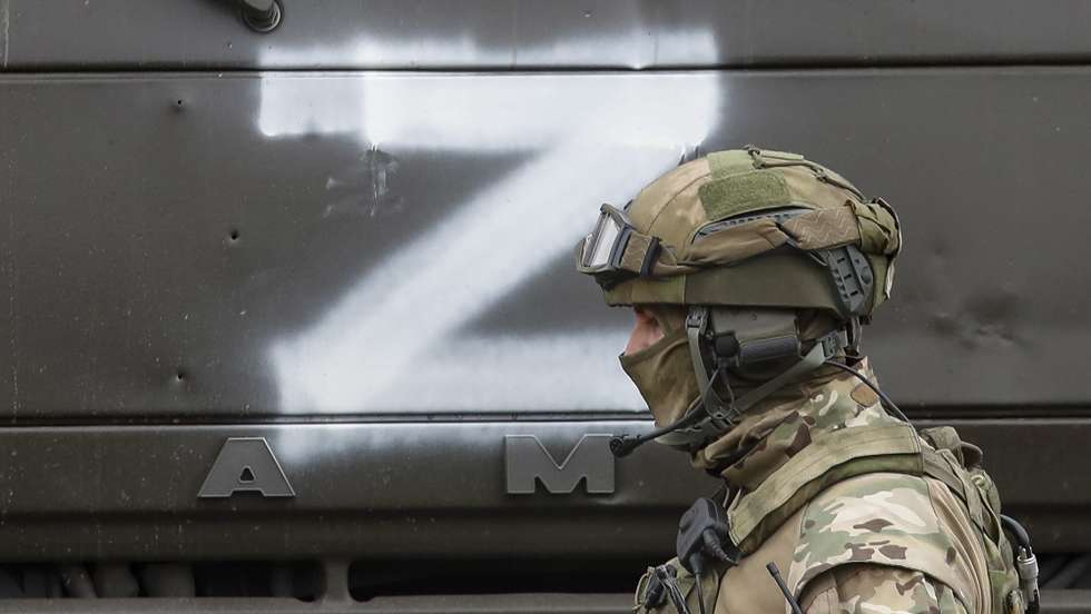 epa09853297 A Russian serviceman guards during food distribution organised by Russian army and militias of self-proclaimed LPR in village Trokhizbenka, Luhansk region, Ukraine, 27 March 2022. Chairman of the Government of the LPR Sergey Kozlov reported that as of March 22, the retreating Kyiv (Kiev) security forces had blown up 22 bridges, but the Republic would restore them. Russia will assist in the restoration and construction of infrastructure in the Republic. On 24 February Russian troops had entered Ukrainian territory in what the Russian president declared a 'special military operation', resulting in fighting and destruction in the country, a huge flow of refugees, and multiple sanctions against Russia. The letter Z has been used by Russian forces as an identifying sign on their vehicles in Ukraine.  EPA/SERGEI ILNITSKY
