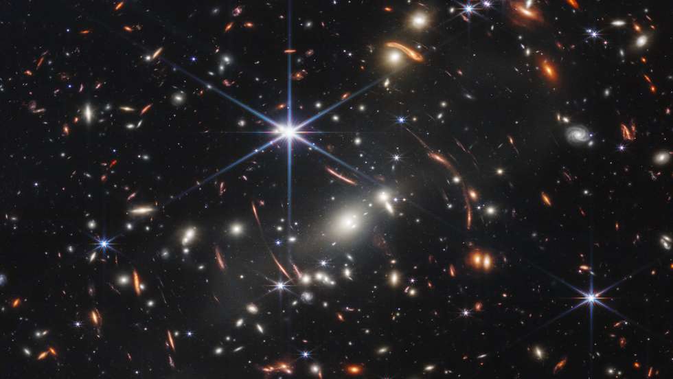 epa10065873 A handout photo made available by Space Telescope Science Institute Office of Public Outreach shows Webb's First Deep Field  taken by Webb's Near-Infrared Camera (NIRCam), a composite made from images at different wavelengths, totaling 12.5 hours, of galaxy cluster SMACS 0723 as it appeared 4.6 billion years ago. The combined mass of this galaxy cluster acts as a gravitational lens, magnifying much more distant galaxies behind it. Webb’s NIRCam has brought those distant galaxies into sharp focus – they have tiny, faint structures that have never been seen before, including star clusters and diffuse features. Researchers will soon begin to learn more about the galaxies' masses, ages, histories, and compositions, as Webb seeks the earliest galaxies in the universe.  EPA/Space Telescope Science Institute Office of Public Outreach HO  EPA-EFE/Space Telescope Science Institute Office of Public Outreach HO  HANDOUT EDITORIAL USE ONLY/NO SALES