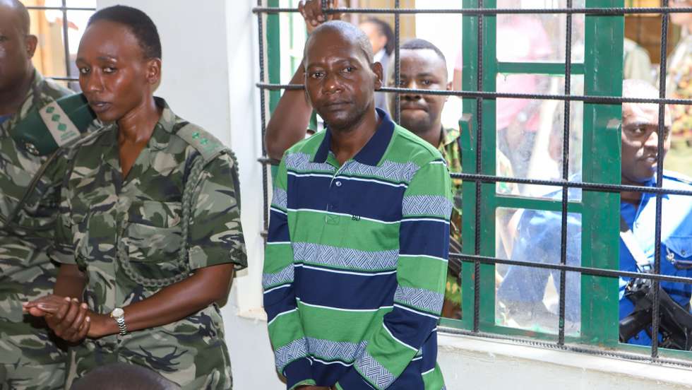 epa11087680 Ex-cult leader Paul Nthenge Mackenzie (R) appears in the Shanzu Courts in Mombasa, Kenya, 18 January 2024. Mackenzie, founder of the Good News International Church, along with 94 co-defendants, were charged with terrorism-related crimes for the deaths of 429 of his followers whose bodies have been exhumed from the Shakahola forest in 2023.  EPA/STR