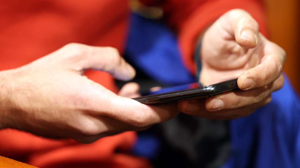 epa11796284 A man uses his smartphone while sitting in a cafe in Tehran, Iran, 28 December 2024. The Iranian government on 27 December 2024 unblocked Whatsapp and Google Play after two years, while the rest of the social media such as Telegram, Instagram, X and YouTube remain blocked.  EPA/ABEDIN TAHERKENAREH