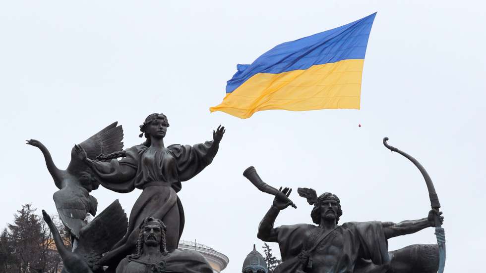 epa09762397 A drone carries a National flag above the Independence Square in Kiev, Ukraine, 16 February 2022. Ukrainians celebrate Unity Day amid escalation on the Ukrainian-Russian border. President Volodymyr Zelensky has declared 16 February as Unity Day for Ukrainians.  EPA/SERGEY DOLZHENKO