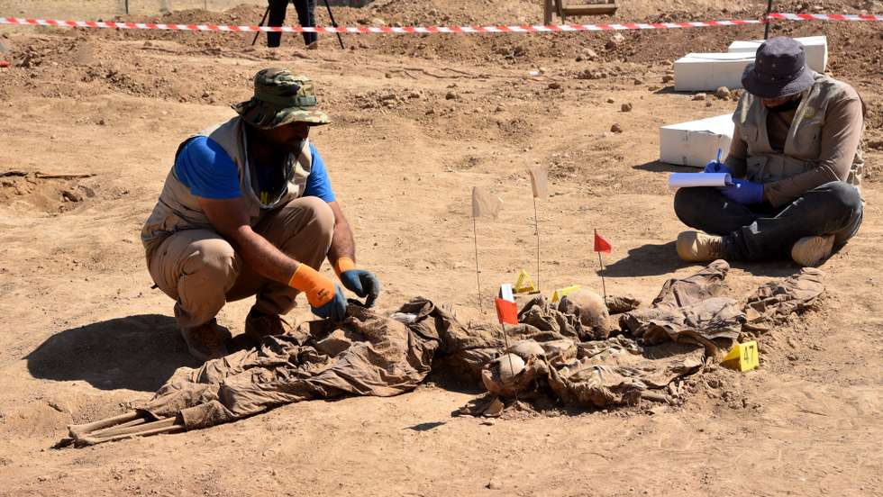 epa09267206 Iraqi forensic personnel work at a site believed to be a mass grave in the Al-Humaydat village, western Mosul city, 500 km north of Baghdad, Iraq, 13 June 2021. Nineveh's Governor, Najm Al-Jubouri announced that "Two mass graves containing about 550 bodies of victims killed and buried by the so-called Islamic State (IS) group, have been found near the Government Badush prison in Mosul, and victims might be the personnel in charge of the prison security among them women". Badush prison was attacked by IS in  June 2014, some  650 Shiite inmates had been killed, the authorities knew of the grave since 2017 when local inhabitants indicated its existence, but wanted to make sure to have the necessary forensic teams capacity to properly identify the victims. Mosul region was under IS control between 2013 and 2017.  EPA/AMMAR SALIH